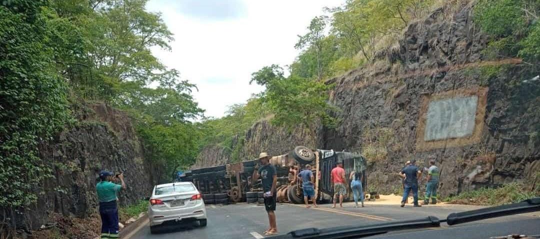 O veículo de carga tombou em uma área cercada por paredões de pedra, resultando no bloqueio total da estrada. (Foto/Divulgação)